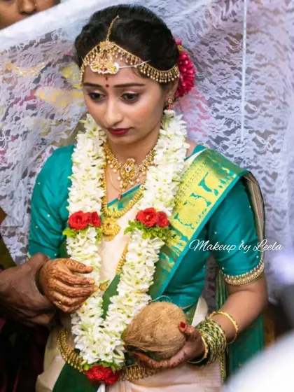 A bride participating in wedding rituals. Her makeup is designed to be sweat-proof and long-lasting, ensuring she looks flawless throughout the traditional ceremonies.