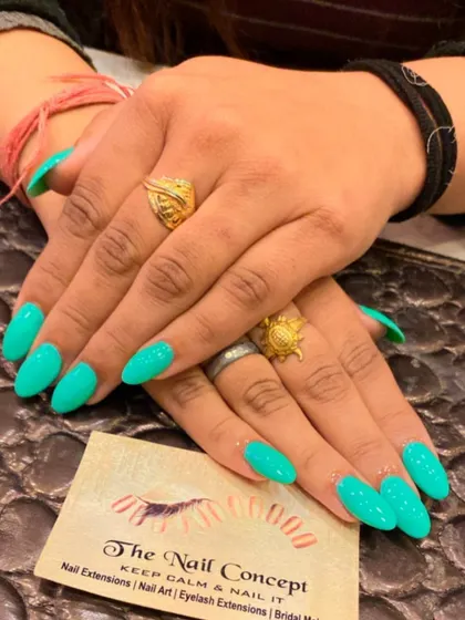 A bright and beautiful set of almond-shaped nails in a solid turquoise color. This vibrant shade is perfect for a beach vacation or a fun summer look.