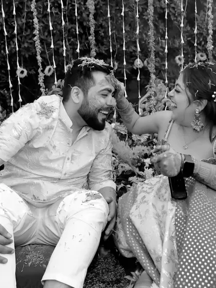 Even in black and white, the joy of the Haldi ceremony shines through. This artistic shot focuses on the couple's interaction, stripping away the color to reveal the pure emotion of the moment.