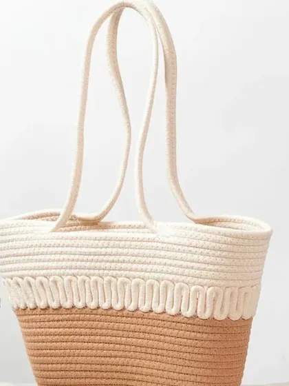 A clean shot of our dual-toned jute rope basket, highlighting its simple, elegant design and sturdy handles.
