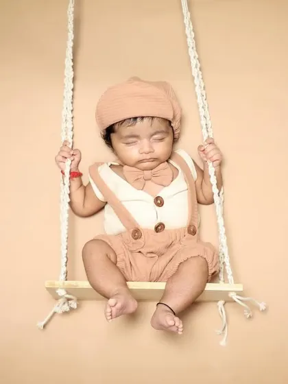 This little gentleman is dressed up and snoozing on a swing. I love styling babies in cute outfits that match the theme of the photoshoot.