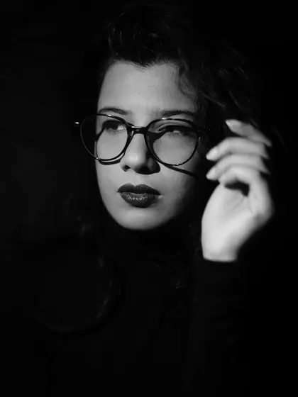 Another pensive look from my black and white portrait experiments. I find that monochrome photography often helps in focusing on pure emotion and form.