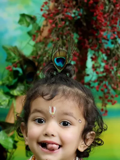 A delightful close up shot highlighting the intricate details of the costume and the child's infectious smile. These portraits are perfect for celebrating Janmashtami or as a timeless keepsake.