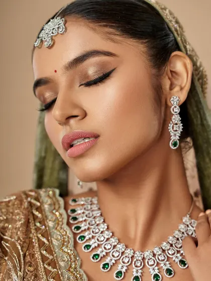 The eyes are closed here, allowing you to see the seamless eyeshadow blending and the precision of the liner. Every detail matters in creating a flawless bridal look.