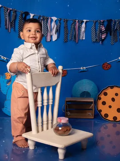 A full view of our Cookie Monster theme, where this little boy is standing proudly by his chair.