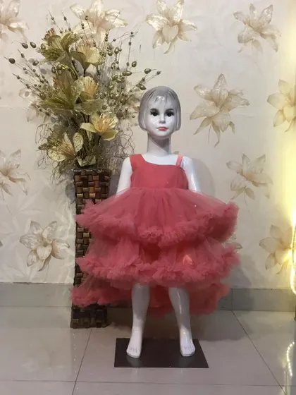 A high-low party frock in pink, with layers of soft ruffles.