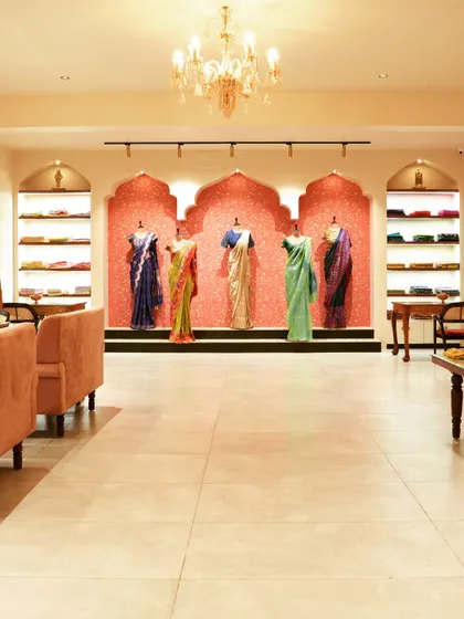 A duplicate of image 13, this wide-angle shot captures the full expanse of the showroom, from the entrance to the main display wall.