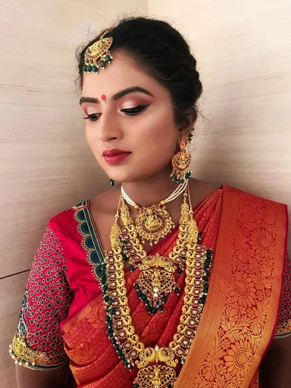 A portrait focusing on the soft, glowing makeup that enhances the bride's features without overpowering her traditional attire.