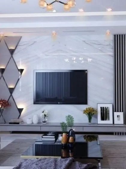 We designed this media wall with a dramatic diamond-patterned mirror accent, which includes integrated sconces for a touch of glamour. The white marble backdrop provides a luxurious contrast to the dark vertical paneling.