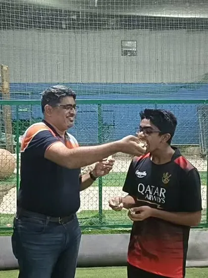 A coach feeds a piece of birthday cake to the player. These are the moments of camaraderie that make our academy a special place.