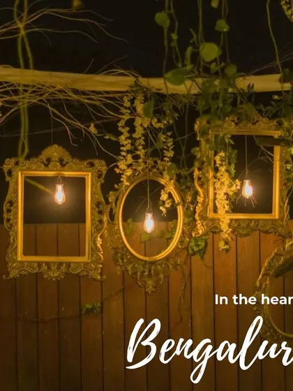 A close-up of our rustic decor with vintage frames and Edison bulbs, perfect for creating a warm and inviting atmosphere in the heart of Bengaluru.
