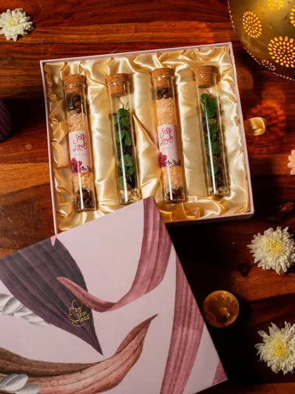 An overhead shot of the Diwali gift box, showcasing the four test tubes filled with mini terrariums and bath salts. This is a thoughtful experience, perfect for gifting or treating yourself.
