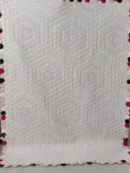 The back of a "Grandmother's Flower Garden" quilt, showing the intricate hexagonal shapes from the reverse.