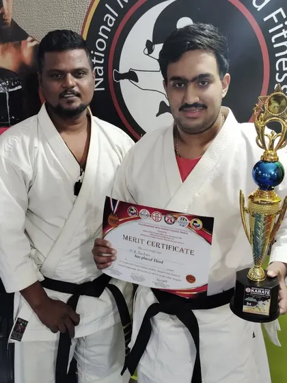 Martial arts is a journey for all ages. Here is one of our adult karate practitioners with his well-earned trophy.