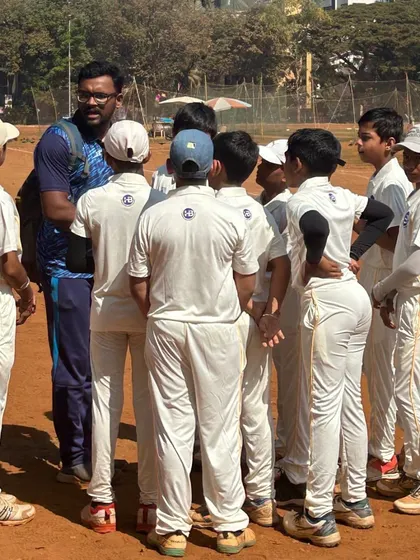A coach gives a pre-game talk to the team at the 9th Bhaskar Thakur Memorial Trophy U12 tournament. Strategy and motivation are key before any important match.