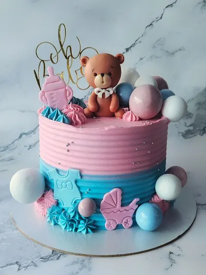 Pink or Blue? A classic baby shower cake with a teddy bear topper. This chocolate truffle cake is perfect for a gender reveal party, with a beautiful ombre effect.