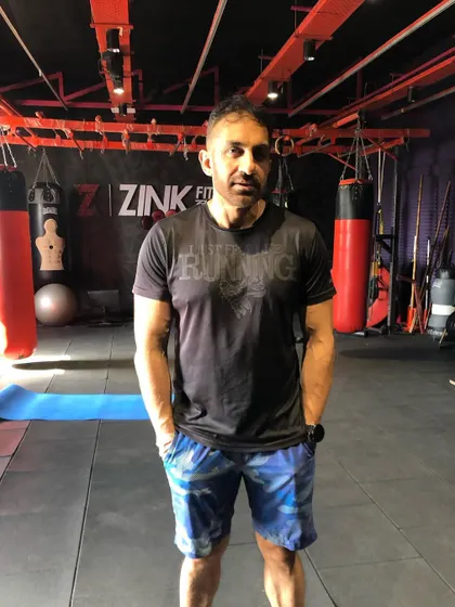 A candid shot of a client in the gym. The determination and focus during a workout are what lead to achieving your goals.
