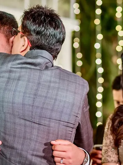 A warm hug between the groom and his father-in-law, symbolizing the welcoming of a new son into the family.