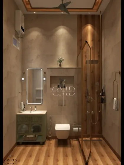 A close-up of the warm, wood-themed bathroom, showing the elegant green vanity and the seamless glass shower partition with gold accents.
