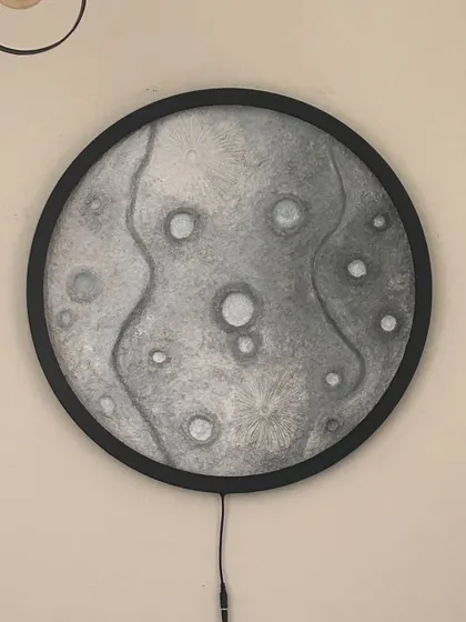 The 24-inch moon lamp with its light off, showing the detailed texture work I did before painting.