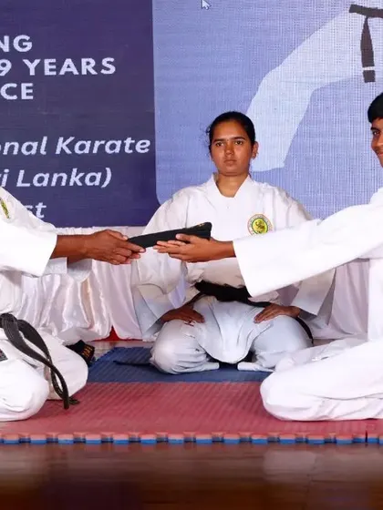 A young student receives his Shodan black belt. This ceremony marks his entry into an advanced stage of karate training and responsibility.