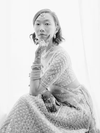 A striking black and white bridal portrait with a modern, editorial feel. The bride's confident pose and direct gaze create a powerful image.