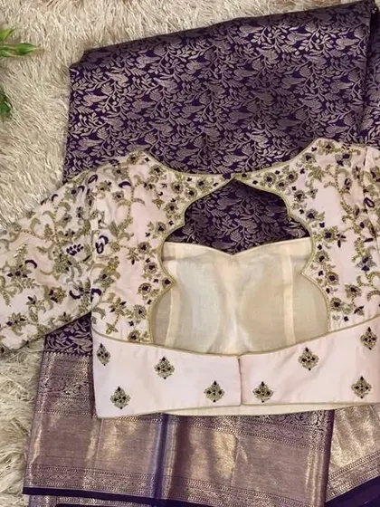 The back of the blush pink blouse, showing the full extent of the intricate floral embroidery.