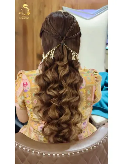 The full view of the Haldi hairstyle, with long, flowing waves and beautiful braided detail at the crown.
