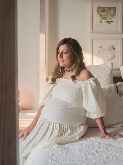 A serene portrait of the mother-to-be, bathed in the soft light from the window. These quiet, contemplative moments are a beautiful part of the pregnancy journey to capture.