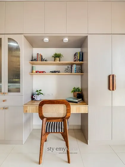 When you need to create multiple functions in a small room, using one wall is a great solution. Here, we designed a single unit that incorporates wardrobes, a study desk, and a mandir, creating a look that is both functional and aesthetically neat.