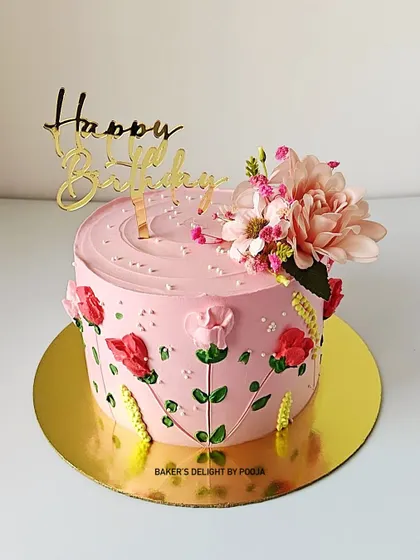 A pretty-in-pink floral cake for a birthday celebration. The hand-piped flowers and fresh bloom on top create a garden-like effect that's both beautiful and delicious.