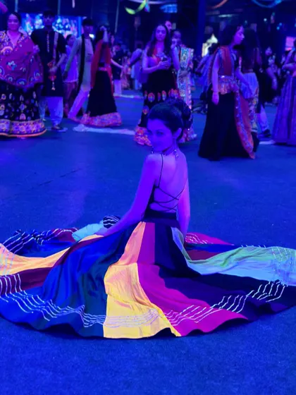 The beauty of a full-circle lehenga spread out on the dance floor. These moments make for fantastic photographs during any Garba or sangeet event.