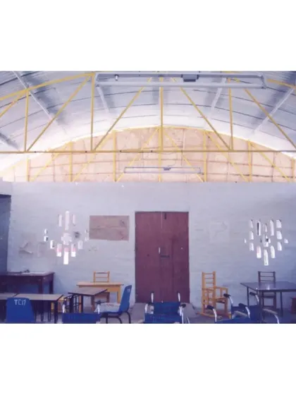 An early photo of the Spastic Society classroom interior, showing the arched roof structure and light filtering in. This demonstrates the evolution of the space over time.