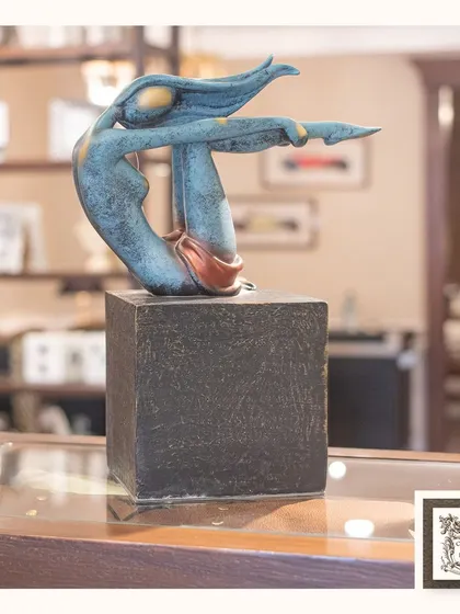 This abstract "Yoga Girl" sculpture captures a moment of balance and serenity. Its fluid lines and modern design make it a beautiful and inspiring showpiece for a shelf or console.