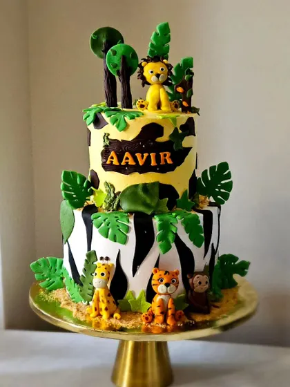 A fun take on the jungle theme, this cake uses camouflage and zebra-stripe patterns. The tiers are decorated with edible leaves and cute, handmade safari animal figurines.