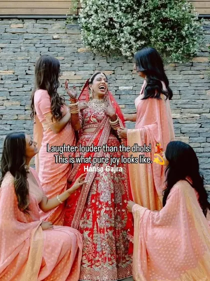 Laughter louder than the dhols. A bride shares a moment of pure joy with her bridesmaids, a beautiful picture of friendship and celebration.