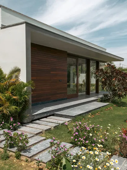 The pool house at Rosewood Farmhouse features a clean, minimal design that complements the main residence. The landscape surrounding it is intentionally soft and colorful, with a mix of flowering perennials and shrubs that contrast beautifully with the modern architecture.