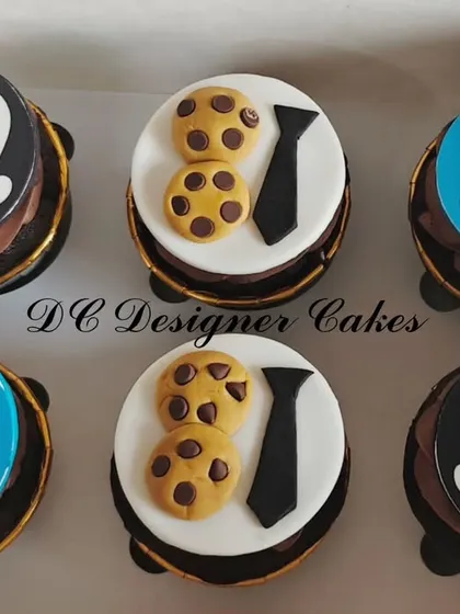 For a "Boss Baby" themed 1st birthday, I created these fun chocolate cupcakes. The fondant toppers feature iconic designs from the movie, like the tie and the cookie.
