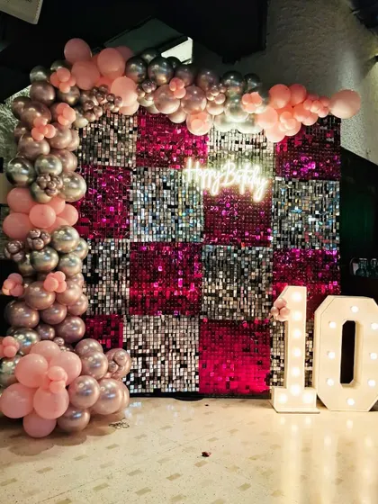 This 10th birthday was all about pink and silver glam. We designed a checkered sequin backdrop in sparkling pink and silver, framed by a matching balloon arch and lit up with marquee numbers. It's a fun and stylish theme for a young fashionista.