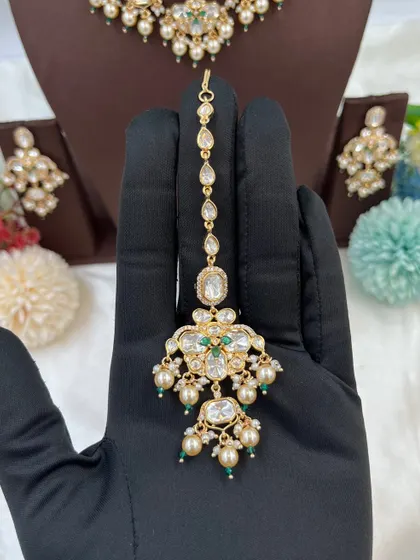 A showcase of our various maang tikkas, designed to match our premium Kundan and Moissanite necklace sets. These accessories complete the bridal look and are a key part of our wholesale sets.