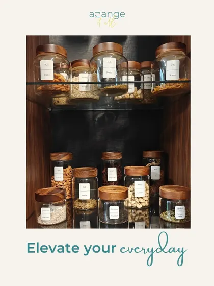 Elevate your everyday with an organized pantry. Glass jars with wooden lids store nuts and dry fruits, turning storage into a beautiful display.