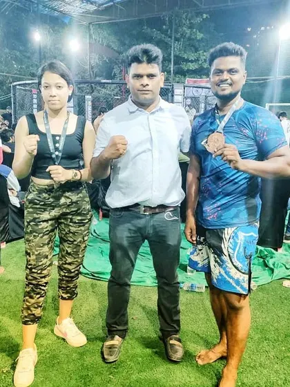 Standing with two of our MMA champions at the National Federation Championship in Mumbai. This picture captures the pride and spirit of our competitive team.