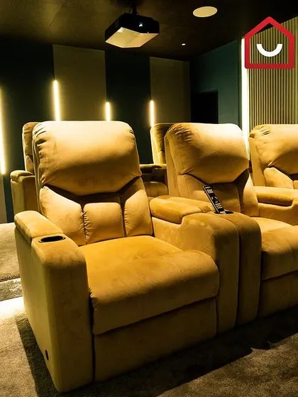 A detailed shot of the plush, motorized recliners, complete with cup holders and wide armrests for maximum comfort during your movie-watching experience.