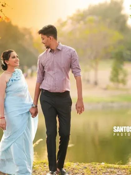 A romantic walk by the lake at sunset, with the warm, golden light reflecting on the water.