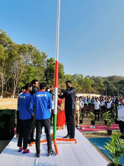 A view from behind the flag-raising party, showing the collective effort involved in the ceremony.