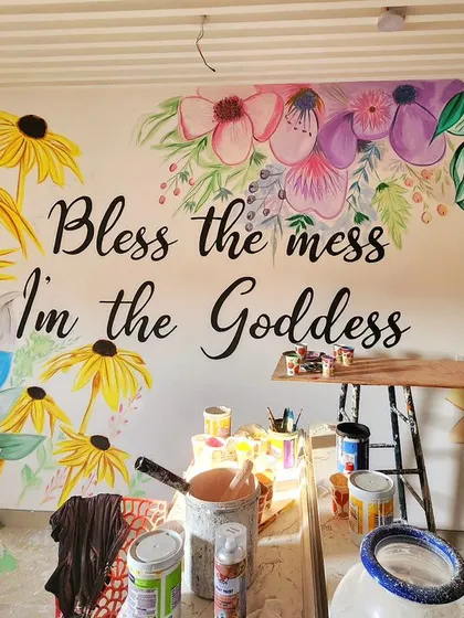 A close-up of the floral mural, showing the watercolor style and the mix of colorful flowers like lotuses and daisies.