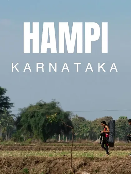 The journey is part of the adventure. Here, two of our crew walk through the paddy fields of Hampi, Karnataka, carrying crash pads on their way to the boulders.