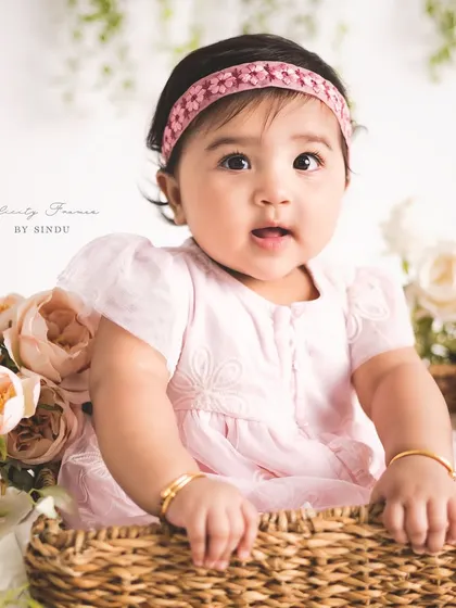 A basket of cuteness! Using props like this wicker basket adds a lovely texture and dimension to sitter portraits, while keeping the baby safe and supported.