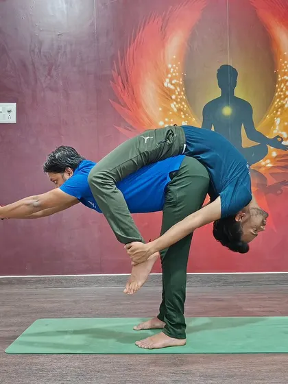 This dynamic partner pose is a beautiful expression of balance and flexibility, requiring both partners to work in harmony.