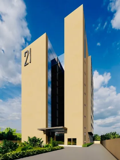 A view of the entrance for the "21" office building. A central glass atrium divides the two solid masses, creating a transparent and inviting entryway that draws natural light deep into the building's core.